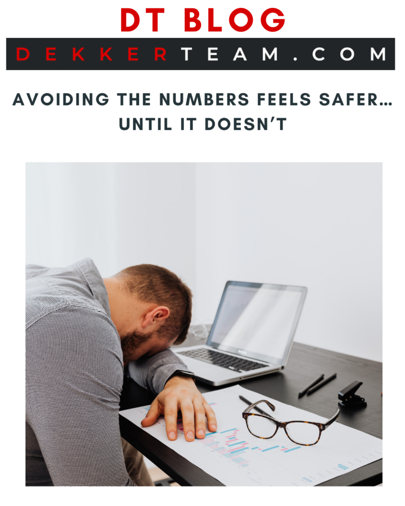 DT blog Read Now Avoiding the Numbers Feels Safer… Until It Doesn’t overtop of an image: A person rests their head on a desk next to a laptop, paperwork, and glasses. 