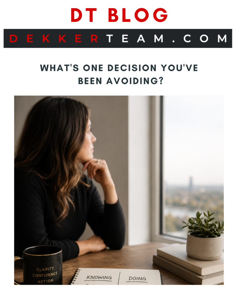 DT blog What's One Decision You've
 Been Avoiding? Read Now A person in a black shirt rests their chin on their hand, looking out a window at a city skyline with a potted plant on the windowsill. 